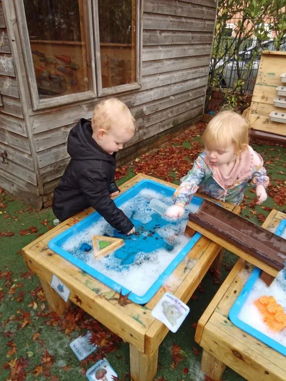 Children playing at an outdoor water table at Roobyloos Nursery